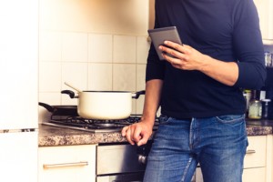 Man with digital reader in kitchen