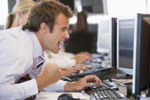 Stock Trader Overjoyed Looking At Monitor