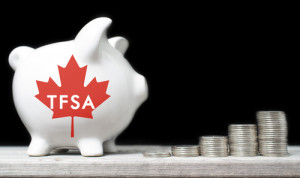 Canadian Tax-Free Savings Account concept with a piggy bank against black background