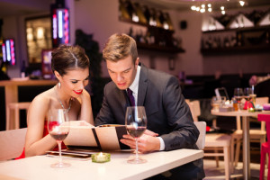 Smiling couple reading menu and choosing meal