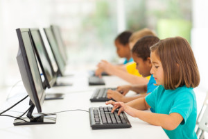 group elementary school students in computer class