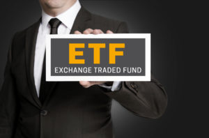 ETF sign is held by businessman.