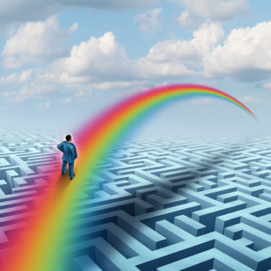 Excel concept as a creative solution to a challenge as a businessman crossing a complicated maze or labyrinth with a bridge made from a rainbow as a success metaphor for visualizing a future accomplishment or virtual reality.